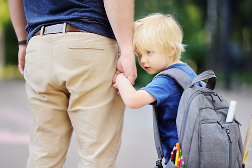 Child holding hands with a parent